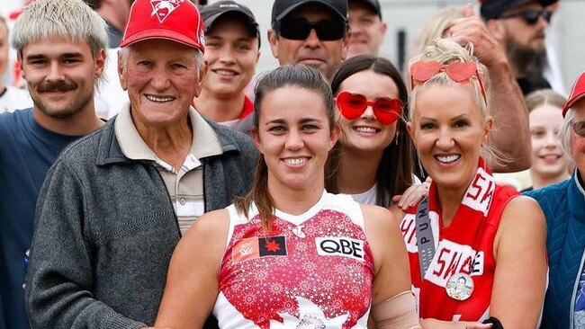 Molloy with her family after celebrating a win with the Swans earlier this year.