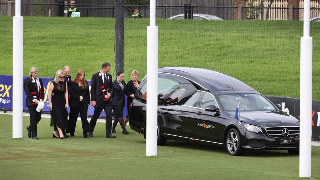 The family lowered their heads as they remembered their lovable larrikin father who touched the hearts of millions of Aussies and fans around the world. Picture: David Caird