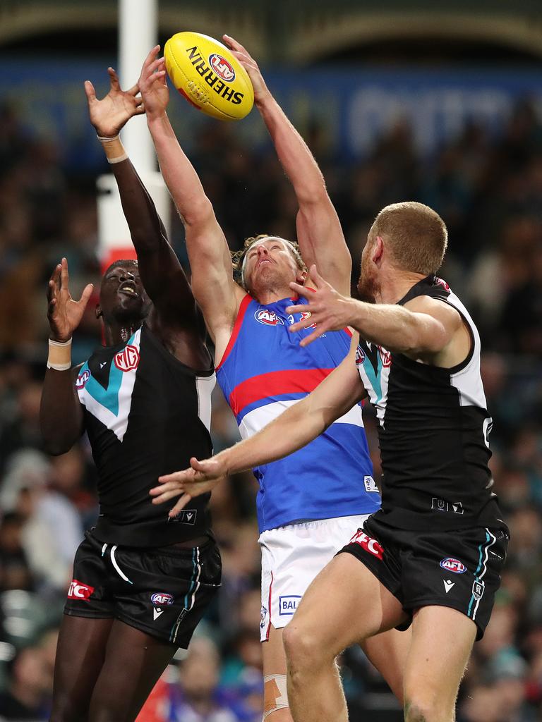 Aaron Naughton outmarks Port Adelaide defenders Aliir Aliir and Tom Clurey. Picture: Sarah Reed/AFL Photos