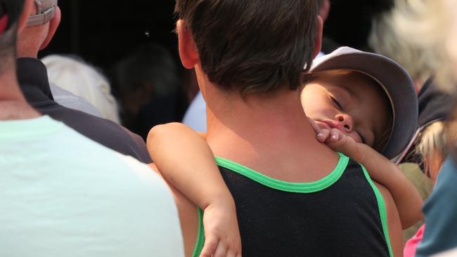 It was all a bit of a snore for one young fella as residents gathered at Yarramalong RFS station for a public information session regarding the Grospers Mountain fire. Picture: Richard Noone