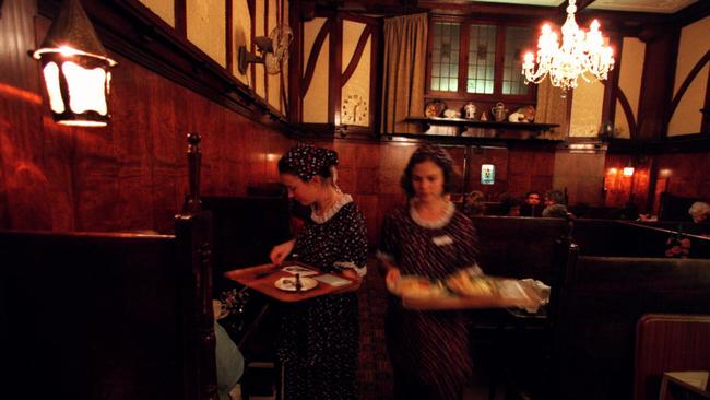 Waitresses carrying trays at Brisbane's original Shingle Inn tearoom in Edward Street circa 1999. Picture: Supplied