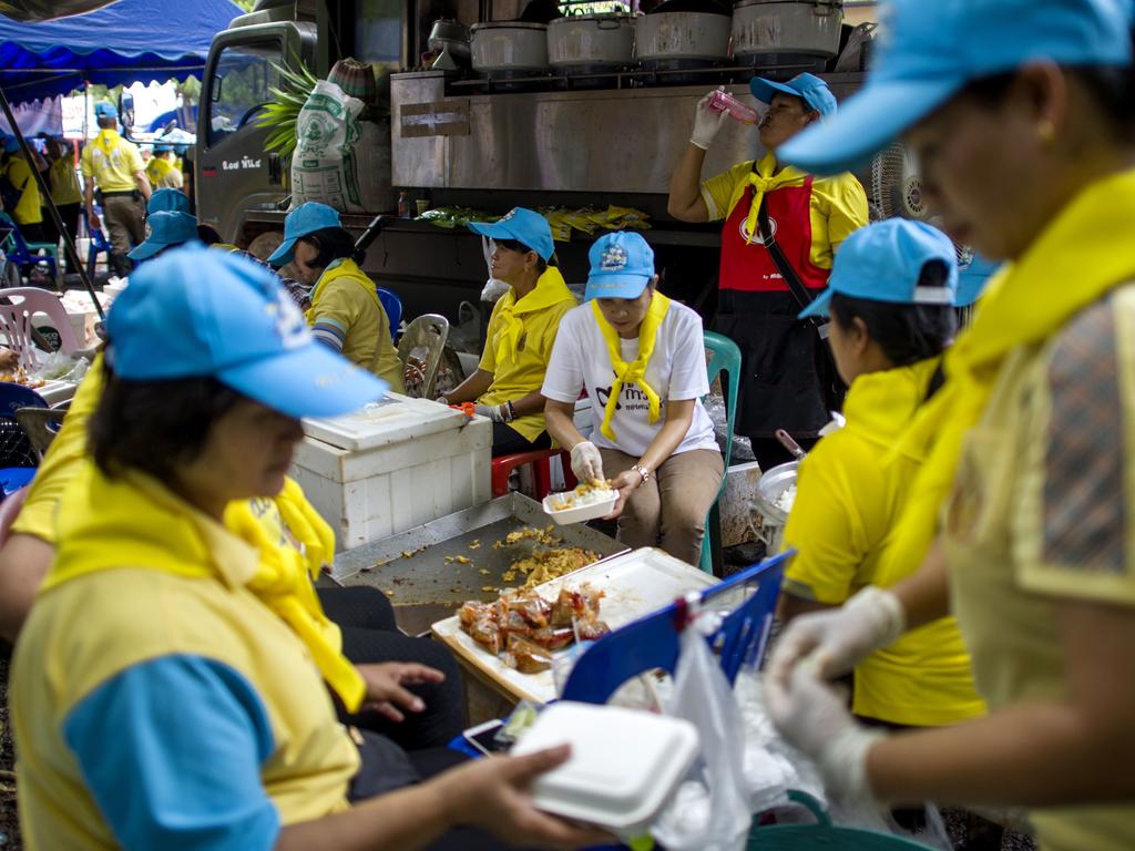 Thai volunteers prepare food in a mobile canteen at the Tham Luang cave area as rescue operations continue for 12 boys and their coach trapped at the cave. Picture: AFP