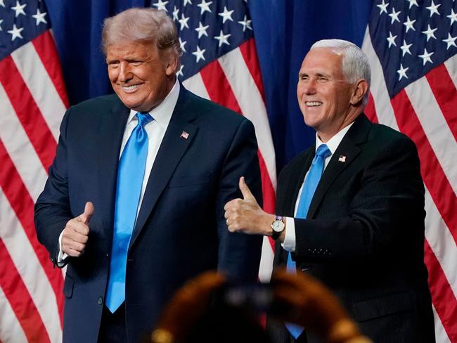 US President Donald Trump and Vice President Mike Pence give a thumbs up after speaking during the first day of the Republican National Convention on August 24, 2020, in Charlotte, North Carolina. - President Donald Trump went into battle for a second term Monday with his nomination at a Republican convention where he will draw on all his showman's instincts to try and change the narrative in an election he is currently set to lose. (Photo by Chris Carlson / POOL / AFP)