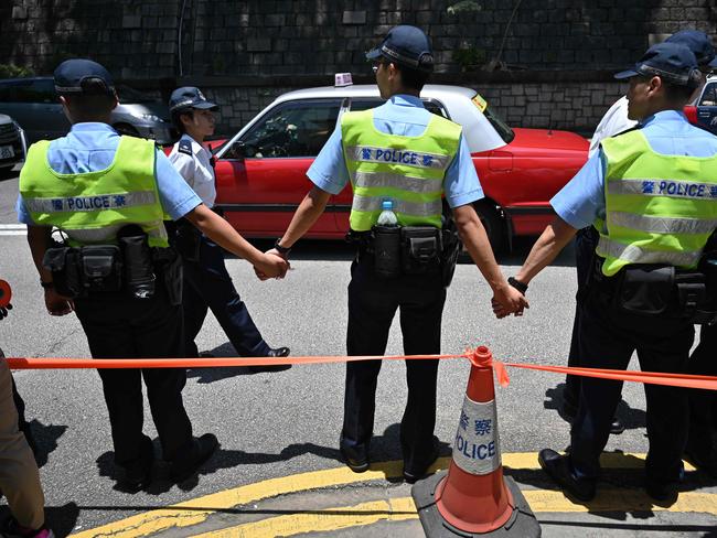 Police stand guard outside Government House in Hong Kong. Picture: AFP