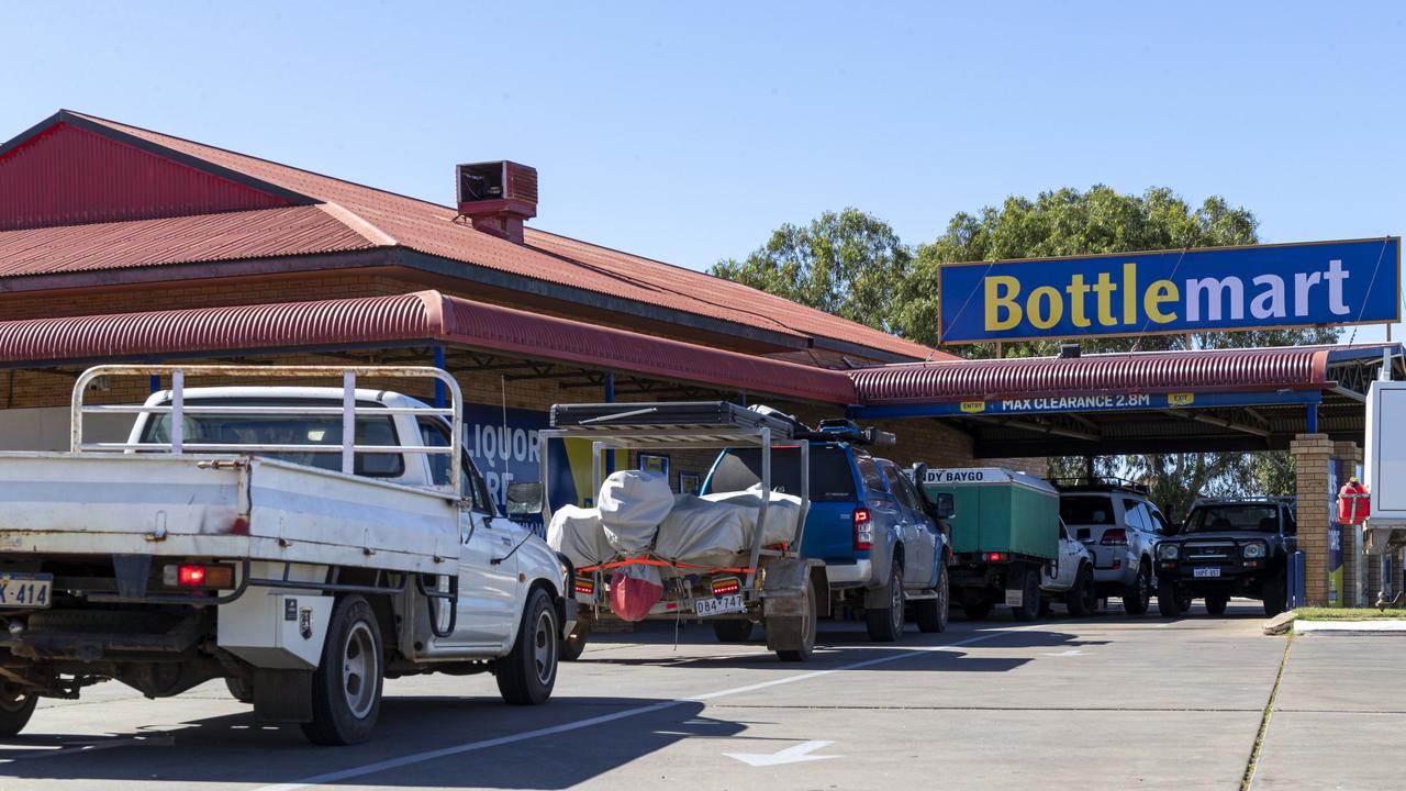 Lines form at bottle shops in Carnarvon after the weekly two-day takeaway alcohol ban. Picture: Jon Gellweiler/news.com.au