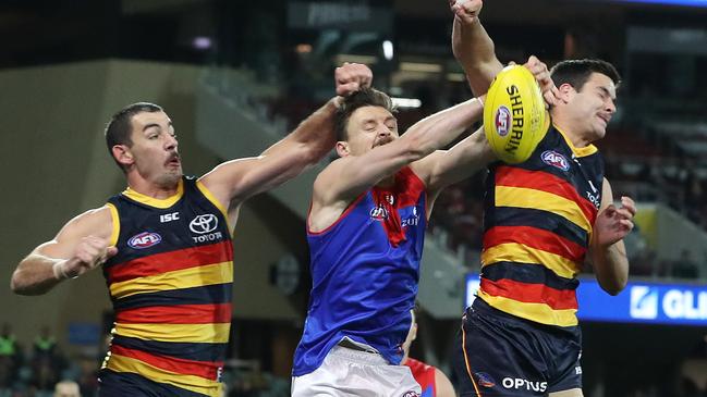 Crows forwards Taylor Walker and Darcy Fogarty can’t beat Melbourne;s Jake Lever to the contest. Picture: Sarah Reed