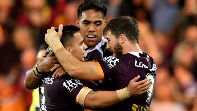 Kodi Nikorima, Joe Ofahengaue and Ben Hunt celebrate a win.