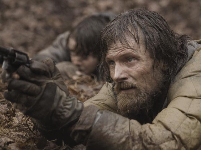 Kodi Smit-McPhee and Viggo Mortensen (R) in a scene from <i>The Road</i>.