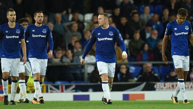 Everton's English striker Wayne Rooney (C) and Everton players react to Apollon Limassol's Spanish defender Hector Yuste scoring his team's second goal.