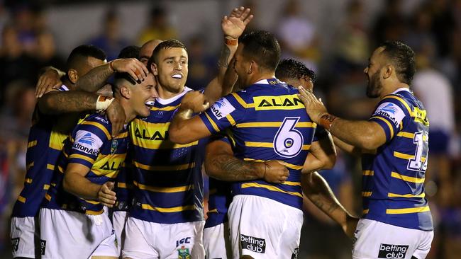 Eels players celebrate a try against the Knights in Maitland.