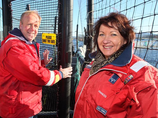 Huon Aquaculture new predator proof fish pens at Hideaway bay, picture of owners Peter and Frances Bender on the new caged floating platform