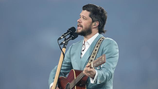 Dylan Wright sings the national anthem before Game 1. (Photo by Cameron Spencer/Getty Images)