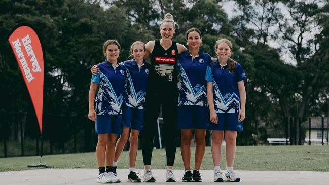 Sydney Flames player Tess Madgen with students from Charlestown South Public School. Picture: Kris Saad