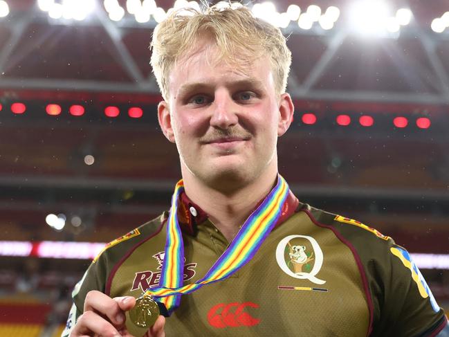 BRISBANE, AUSTRALIA - APRIL 25:  Tom Lynagh of the Reds hold the ANZAC medal after the round 11 Super Rugby Pacific match between Queensland Reds and Blues at Suncorp Stadium, on April 25, 2025, in Brisbane, Australia. (Photo by Chris Hyde/Getty Images)