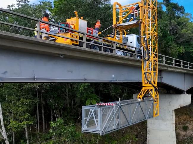 Roadtek employees work on the underside of the Barron River bridge at Kuranda. Picture: TMR