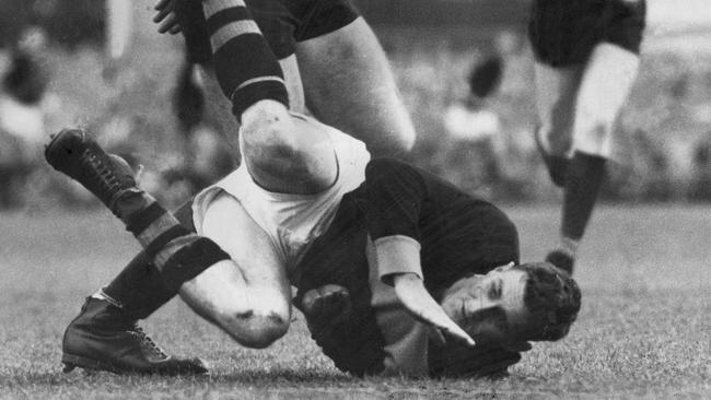 Richmond and Ballarat winger Tom Simpson on the ground during a match against Fitzroy in 1958. Picture: NewsCorp Australia.