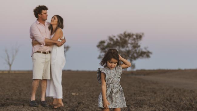 Monique and Tom Cush with their daughter Andrea on their cotton farm on the Queensland-NSW border. Picture: Melissa Carrigan