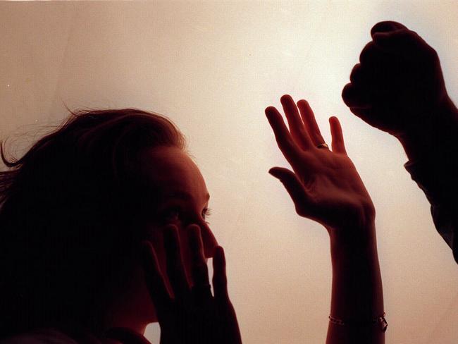 Domestic violence silhouette generic image - fist raised against woman./Violence