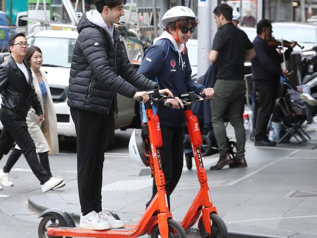 E scooters in the CBD. People on hire scooters in Little Collins street.  Tuesday, October 4, 2022. Picture: Herald Sun