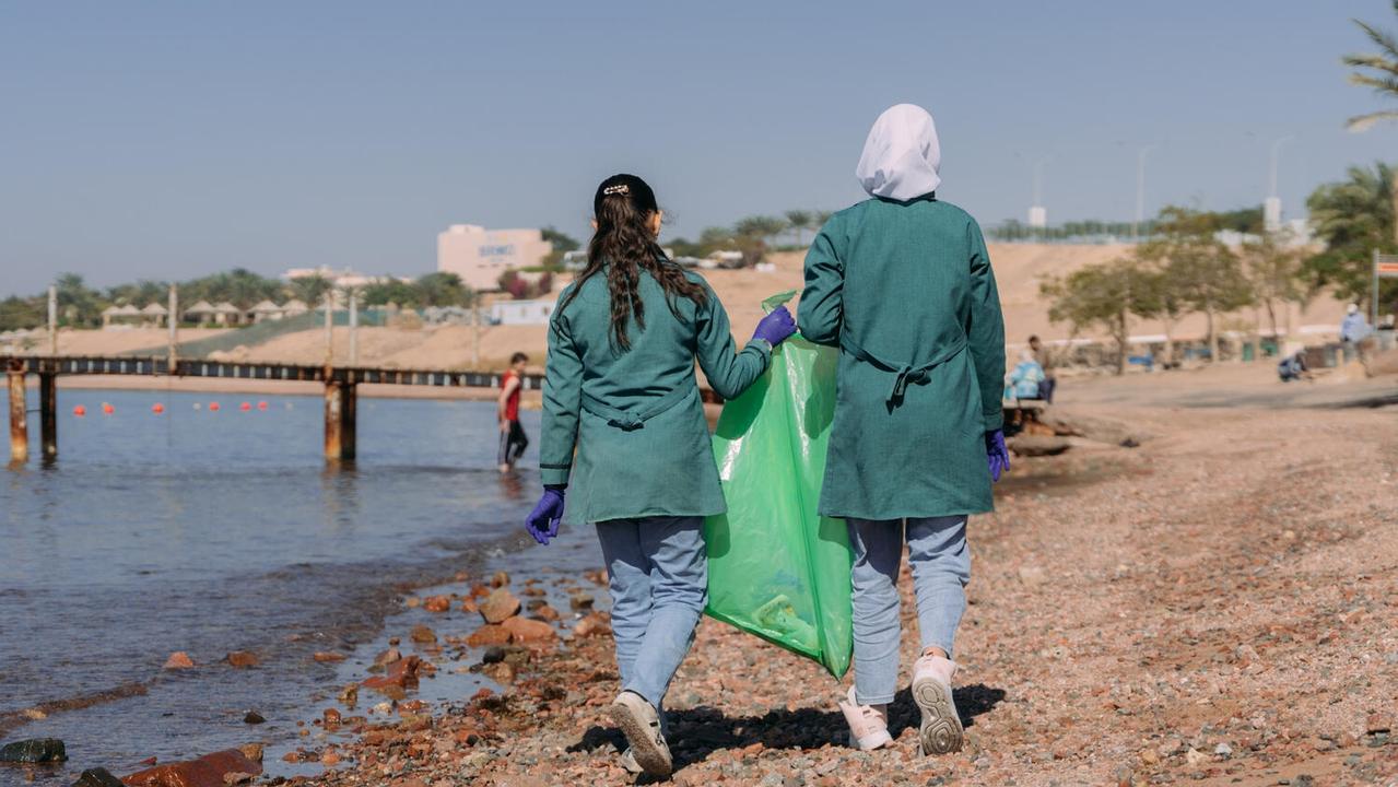 Year 7 student Tala picks up rubbish as part of the UNICEF-supported Climate Action Club at her school in Jordan. Picture: UNICEF/Jude Al-Safadi