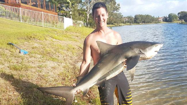 Heath Simmons with a bull shark he caught at Burleigh Lake. Photo: Facebook.