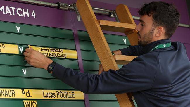 The names of Andy Murray and Emma Raducanu are removed from the order of play board as Raducanu announces her withdrawal from the mixed doubles at Wimbledon. Picture: Julian Finney/Getty Images