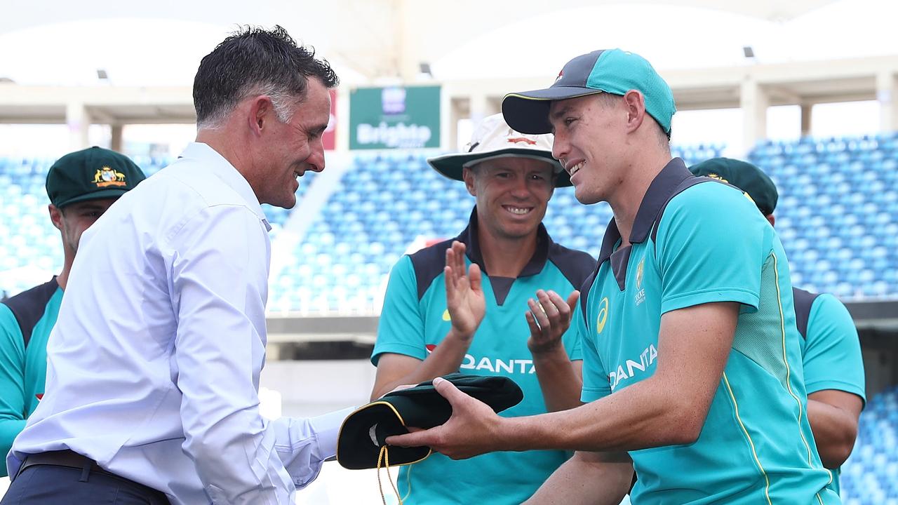 Marnus Labuschagne receives his baggy green from Mike Hussey.