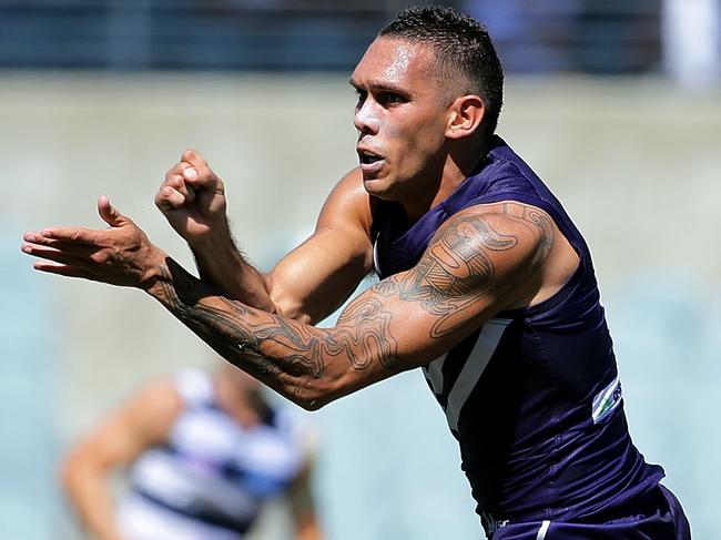 PERTH, AUSTRALIA - MARCH 12: Harley Bennell of the Dockers handballs during the 2016 NAB Challenge match between the Fremantle Dockers and the Geelong Cats at Domain Stadium, Perth on March 12, 2016. (Photo by Will Russell/AFL Media/Getty Images)