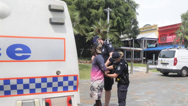 Police arrest a man on Shields St after allegedly causing a disturbance. Picture: Peter Carruthers