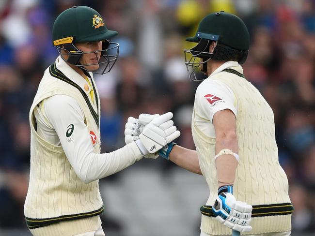 MANCHESTER, ENGLAND - SEPTEMBER 04: Marnus Labuschagne of Australia shakes hands with Steven Smith after reaching his half century during day one of the 4th Specsavers Ashes Test between England and Australia at Old Trafford on September 04, 2019 in Manchester, England. (Photo by Gareth Copley/Getty Images)