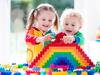 Child playing with colorful toys. Little girl and funny curly baby boy with educational toy blocks. Children play at day care or preschool. Mess in kids room. Toddlers build a tower in kindergarten. Picture: iStock