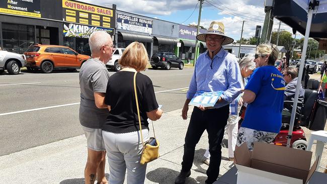 Southport MP Rob Molhoek handing out how-to-vote cards for voters outside the Gold Coast prepoll voting booth.