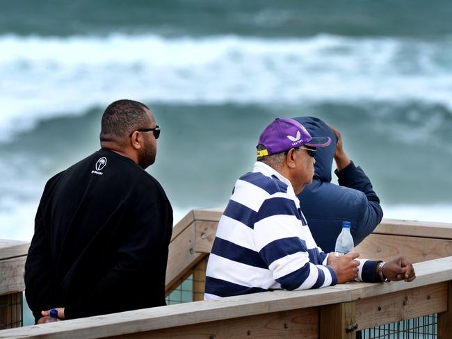 Joji Kinivuwai and family wait for news at Number 16 Beach at Rye. Picture: Andrew Henshaw