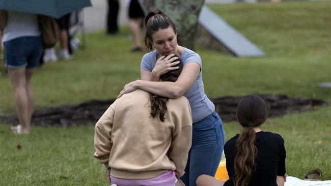 A woman being consoled at the candlelight vigil at Lake Eden, North Lakes to celebrate the life of Emma Lovell, on Friday, December 30, 2022. Picture: Richard Walker