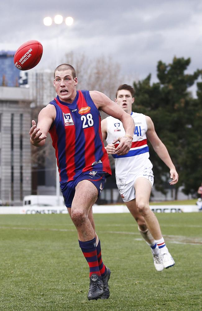 Port Melbourne ruckman Tom Goodwin runs on to the ball.