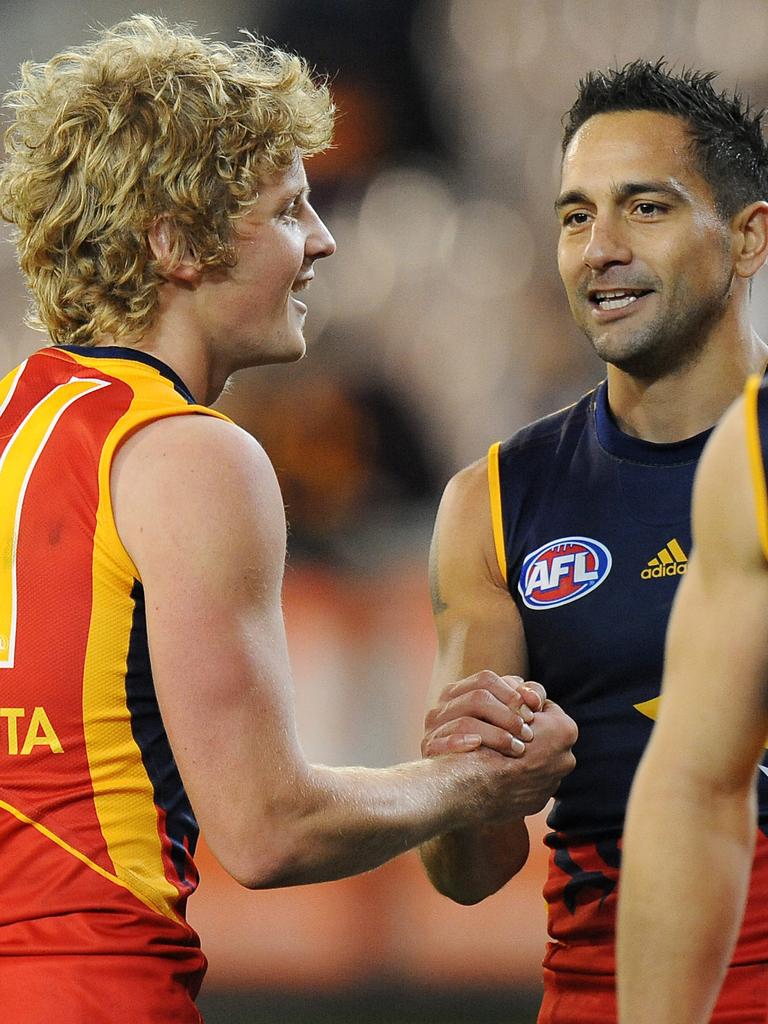 Sloane celebrates with Andrew McLeod after his debut against the Hawks.