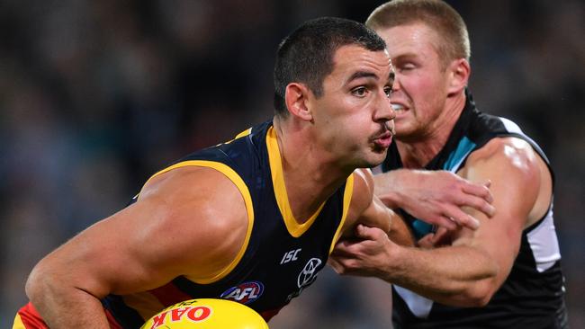 Taylor Walker of the Crows is tackled by Tom Clurey of the Power. Picture: AAP Image/David Mariuz