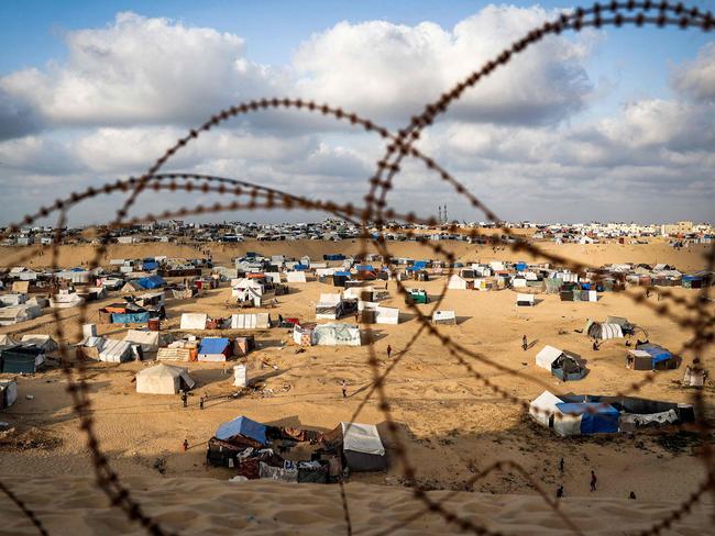 Tents housing displaced Palestinians are pictured behind barbed wire in Rafah in the southern Gaza Strip. Picture: AFP