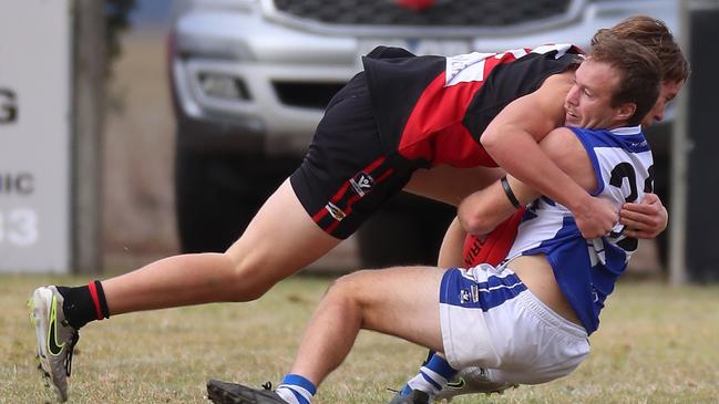 Irrewarra-Beac’s Hudson Dewar stops South Colac’s Brendan Monaghan in his tracks.