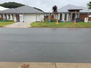 Cracks in the road at Greenvale Crescent at Riverstone Crossing on the Gold Coast where there has been a landslip.