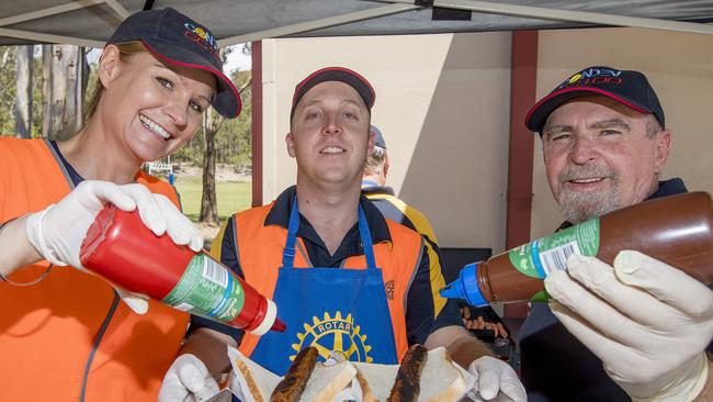 Queensland Election day. Justine Marshall, Cameron Glenister and Ron Wilson from the Rotary are keeping the voters topped up on food at Arundel State School. Picture: Jerad Williams