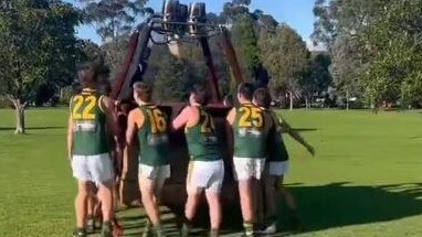 Hampton Rovers players move a hot air balloon basket. Picture: Hampton Rovers Twitter