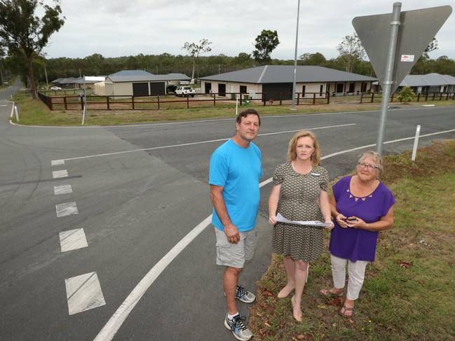 Cr Laurie Koranski (center) poses with Buccan residents Troy Ellison and Helene Hutson, on a street, near Logan, Thursday February 1, 2018. The residents and Cr Koranski are concerned about the speed limit on Latimer and Stegemann roads. (AAP Image/Jono Searle)