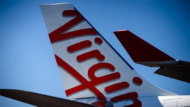 Virgin Australia aircraft are seen parked on the tarmac at Brisbane International airport on April 21, 2020. Picture: AFP