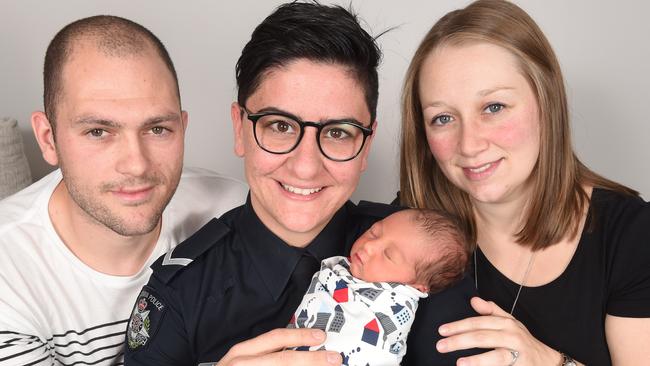 First Constable Alana Olivieri holds baby Charles with parents Kyle and Melissa Sherwood. Picture: Tony Gough