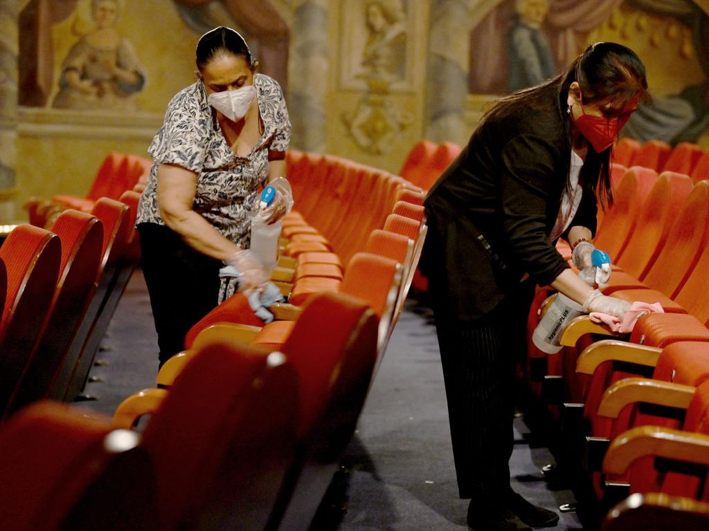 Workers clean a cinema in Salzburg as cultural institutions prepare to reopen. Picture: AFP