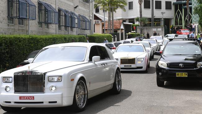 A procession of Rolls Royces and Bentleys follow the hearse carrying the coffin of Hawi after his funeral.