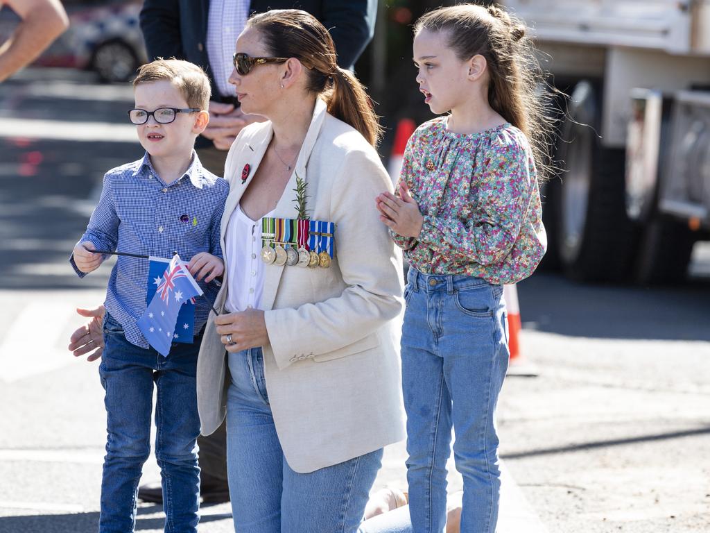 Ex-army Sarah Long and her children Thomas and Sophie watch Toowoomba's Anzac Day mid-morning march to the Mothers' Memorial, Thursday, April 25, 2024. Picture: Kevin Farmer