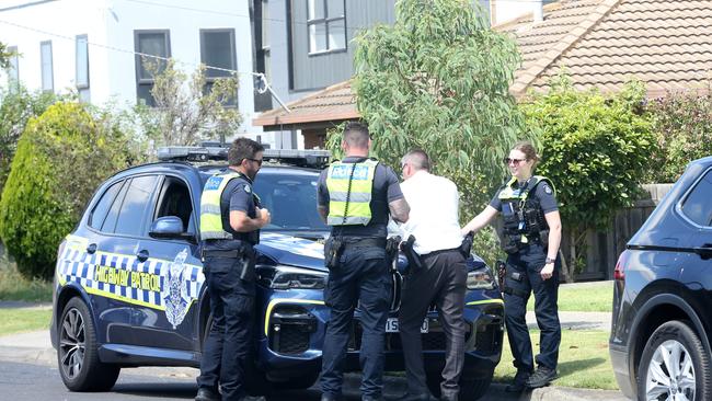 Detectives and officers from Victoria Police at the Corio scene on Monday. Picture: Alan Barber