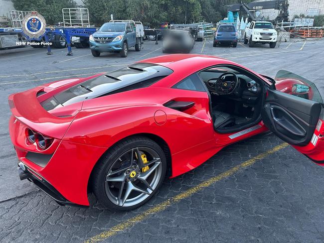 Financial Crimes Squad detectives charged two men after an investigation into a cryptocurrency scam which allegedly defrauded two companies of more than $5.5 million. A Ferrari valued at $500,000 was seized by police. Picture: NSW Police